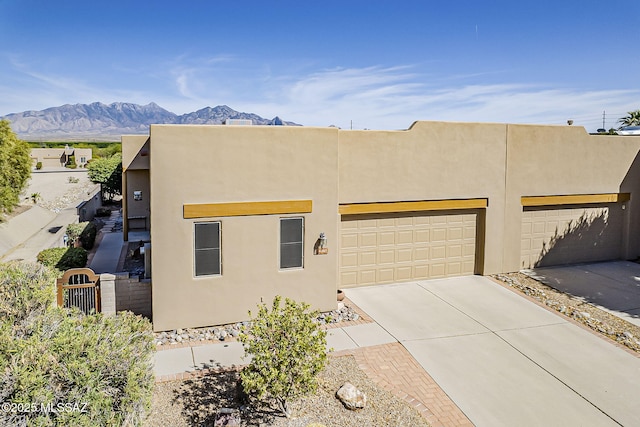 4043 S Golden Lynx Rd, Green Valley, AZ 85614 - adobe home featuring a mountain view, concrete driveway, an attached garage, and stucco siding