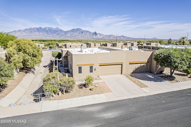 4043 S Golden Lynx Rd, Green Valley, AZ 85614 - pueblo-style house with stucco siding, a mountain view, an attached garage, and driveway