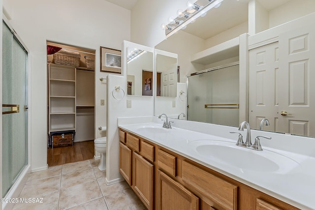 4043 S Golden Lynx Rd, Green Valley, AZ 85614 - full bathroom with a shower stall, tile patterned flooring, double vanity, and toilet