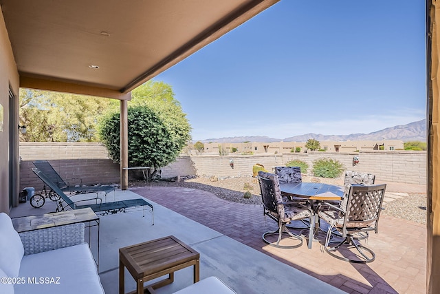 4043 S Golden Lynx Rd, Green Valley, AZ 85614 - view of patio with a mountain view, outdoor dining area, and a fenced backyard