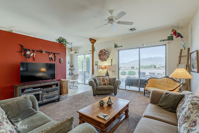 4043 S Golden Lynx Rd, Green Valley, AZ 85614 - living room featuring a ceiling fan, a mountain view, and carpet floors