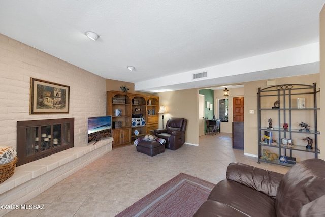 571 N Tanque Verde Loop Rd, Tucson, AZ 85748 - living room featuring light tile patterned floors and a fireplace