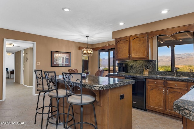 571 N Tanque Verde Loop Rd, Tucson, AZ 85748 - kitchen featuring black dishwasher, light tile patterned floors, a kitchen breakfast bar, a chandelier, and recessed lighting