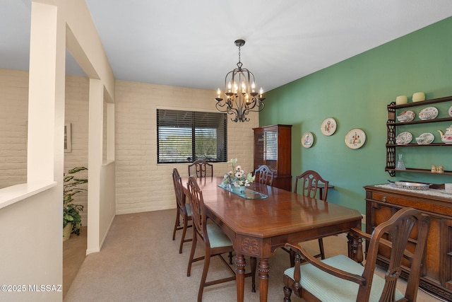 571 N Tanque Verde Loop Rd, Tucson, AZ 85748 - carpeted dining space with a chandelier and brick wall