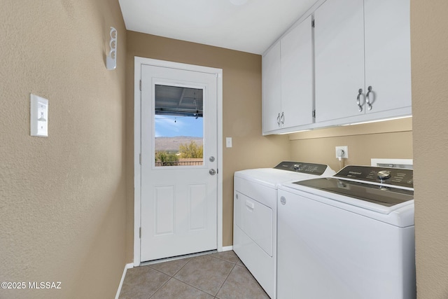 571 N Tanque Verde Loop Rd, Tucson, AZ 85748 - washroom with cabinet space, washing machine and dryer, light tile patterned floors, and a textured wall