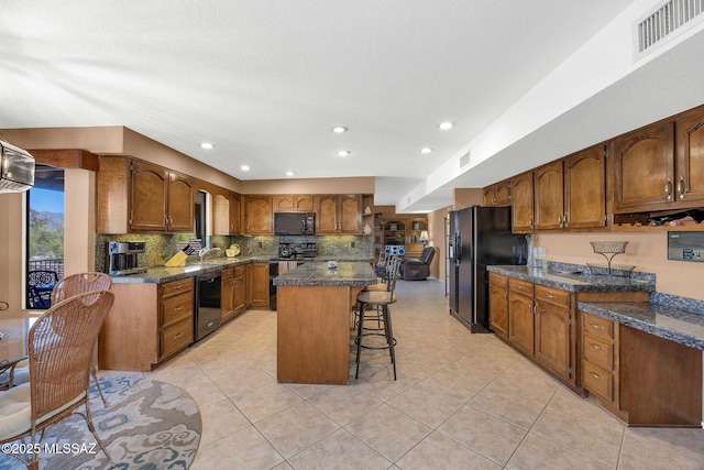 571 N Tanque Verde Loop Rd, Tucson, AZ 85748 - kitchen with black appliances, a breakfast bar area, a center island, backsplash, and light tile patterned floors