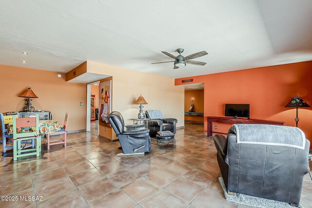 241 W Calle Mccleary, Green Valley, AZ 85614 - living room with ceiling fan, light tile patterned floors, and baseboards