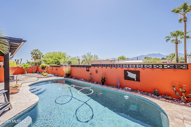 241 W Calle Mccleary, Green Valley, AZ 85614 - view of swimming pool with a mountain view, a fenced backyard, and a patio area