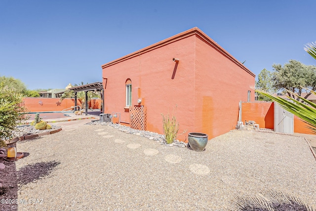 241 W Calle Mccleary, Green Valley, AZ 85614 - view of side of property featuring a patio area, fence, and stucco siding