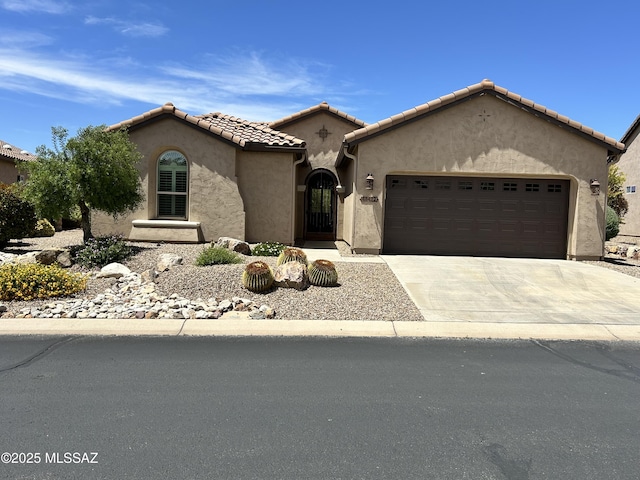 60422 E Arroyo Vista Dr, Oracle, AZ 85623 - mediterranean / spanish-style home featuring a garage, concrete driveway, stucco siding, and a tiled roof