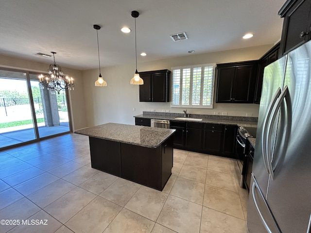 60422 E Arroyo Vista Dr, Oracle, AZ 85623 - kitchen featuring appliances with stainless steel finishes, dark cabinetry, a center island, stone counters, and recessed lighting