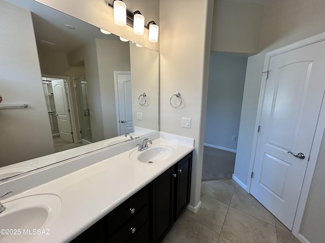 60422 E Arroyo Vista Dr, Oracle, AZ 85623 - full bathroom with a shower stall, double vanity, tile patterned floors, and baseboards