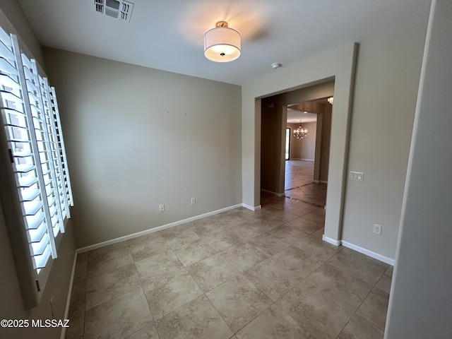 60422 E Arroyo Vista Dr, Oracle, AZ 85623 - tiled empty room featuring a chandelier and baseboards
