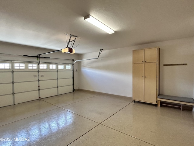 60422 E Arroyo Vista Dr, Oracle, AZ 85623 - garage featuring a garage door opener and baseboards