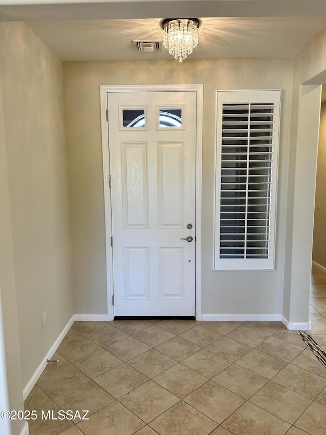 60422 E Arroyo Vista Dr, Oracle, AZ 85623 - entryway with light tile patterned flooring, a chandelier, and baseboards