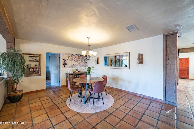 2120 N Fair Oaks Ave, Tucson, AZ 85712 - tiled dining area with a chandelier, baseboards, and a textured ceiling