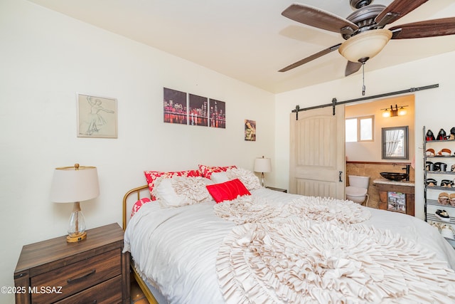 2120 N Fair Oaks Ave, Tucson, AZ 85712 - bedroom featuring a barn door and ensuite bath