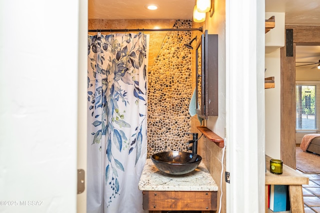 2120 N Fair Oaks Ave, Tucson, AZ 85712 - bathroom view of vanity, curtained shower, backsplash, ceiling fan, and recessed lighting