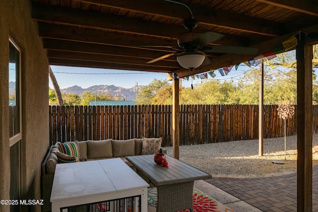 2120 N Fair Oaks Ave, Tucson, AZ 85712 - fenced backyard with a mountain view, ceiling fan, a patio area, and outdoor lounge area