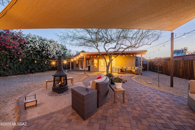 2120 N Fair Oaks Ave, Tucson, AZ 85712 - fenced backyard featuring an outdoor living space with a fire pit and a patio