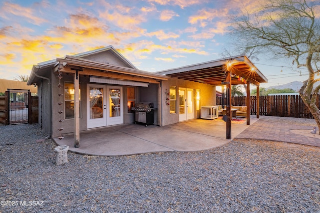 2120 N Fair Oaks Ave, Tucson, AZ 85712 - back of house with french doors, a patio area, and stucco siding