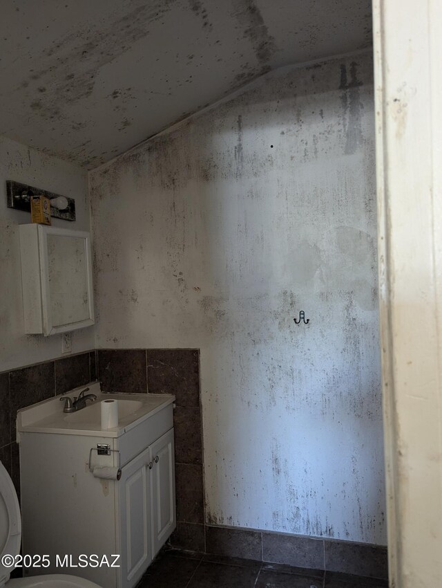 bathroom featuring vanity, tile patterned floors, and toilet