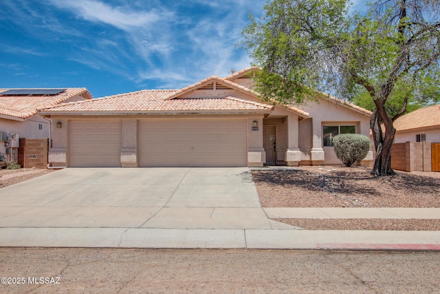 8145 E Smooth Sumac Ln, Tucson, AZ 85710 - view of front of property featuring an attached garage, a tiled roof, stucco siding, and concrete driveway
