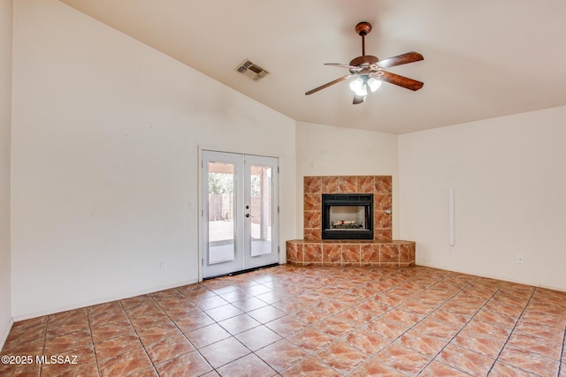 8145 E Smooth Sumac Ln, Tucson, AZ 85710 - unfurnished living room with french doors, lofted ceiling, a ceiling fan, and a fireplace with raised hearth