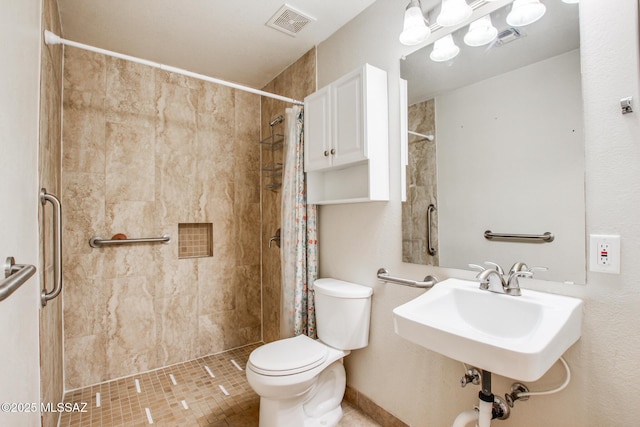 8145 E Smooth Sumac Ln, Tucson, AZ 85710 - bathroom with toilet, a tile shower, and a sink