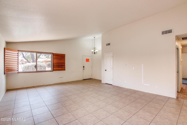 8145 E Smooth Sumac Ln, Tucson, AZ 85710 - spare room featuring a chandelier, high vaulted ceiling, and light tile patterned floors