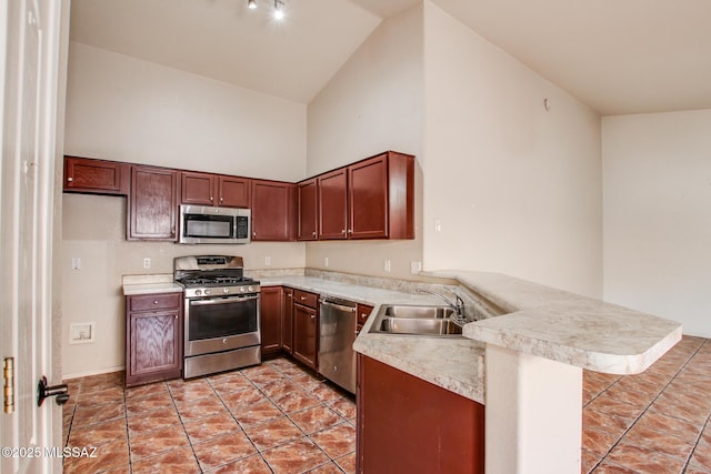 8145 E Smooth Sumac Ln, Tucson, AZ 85710 - kitchen featuring appliances with stainless steel finishes, a sink, a peninsula, high vaulted ceiling, and light countertops