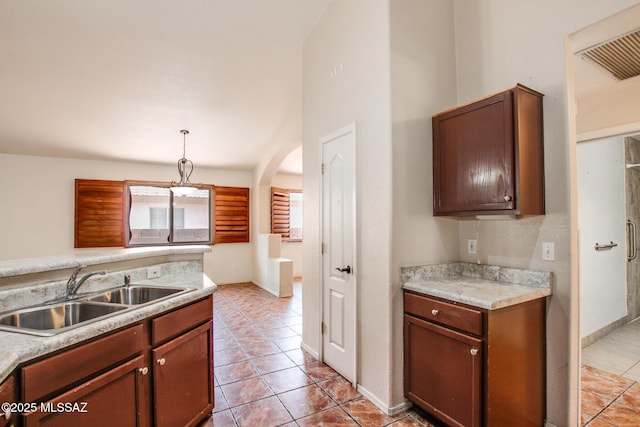 8145 E Smooth Sumac Ln, Tucson, AZ 85710 - kitchen featuring a sink, light tile patterned floors, light countertops, and decorative light fixtures