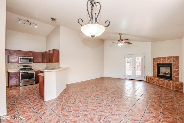 8145 E Smooth Sumac Ln, Tucson, AZ 85710 - kitchen with appliances with stainless steel finishes, open floor plan, light countertops, a peninsula, and light tile patterned floors