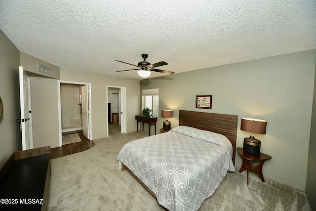 980 W Camino Sagasta, Green Valley, AZ 85622 - bedroom featuring carpet, ceiling fan, a textured ceiling, and connected bathroom