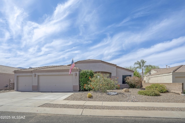519 W Silvertip Rd, Tucson, AZ 85737 - view of front facade featuring stucco siding, an attached garage, driveway, and a tile roof