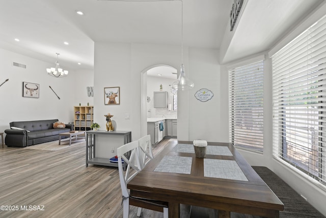 519 W Silvertip Rd, Tucson, AZ 85737 - dining room featuring arched walkways, wood finished floors, a chandelier, recessed lighting, and baseboards