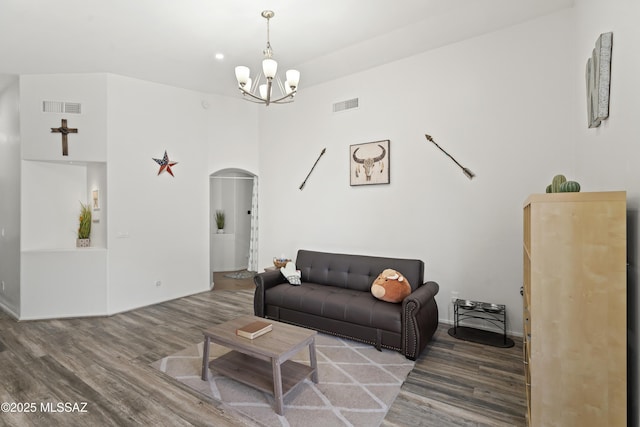 519 W Silvertip Rd, Tucson, AZ 85737 - living area featuring arched walkways, wood finished floors, a chandelier, and baseboards