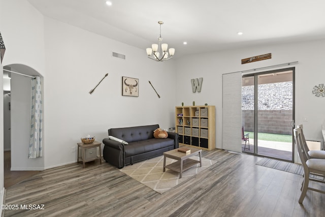 519 W Silvertip Rd, Tucson, AZ 85737 - living area featuring wood finished floors, a chandelier, recessed lighting, arched walkways, and baseboards