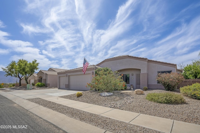 519 W Silvertip Rd, Tucson, AZ 85737 - mediterranean / spanish-style home featuring stucco siding, driveway, a garage, and a tiled roof