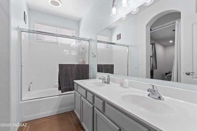 519 W Silvertip Rd, Tucson, AZ 85737 - bathroom featuring connected bathroom, double vanity, and enclosed tub / shower combo