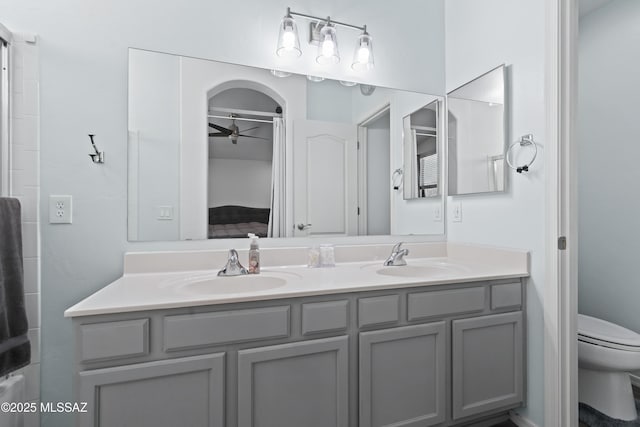 519 W Silvertip Rd, Tucson, AZ 85737 - bathroom featuring double vanity, toilet, ceiling fan, and ensuite bath