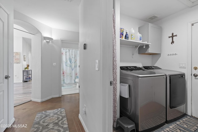 519 W Silvertip Rd, Tucson, AZ 85737 - laundry area with independent washer and dryer, cabinet space, light wood-style floors, and baseboards