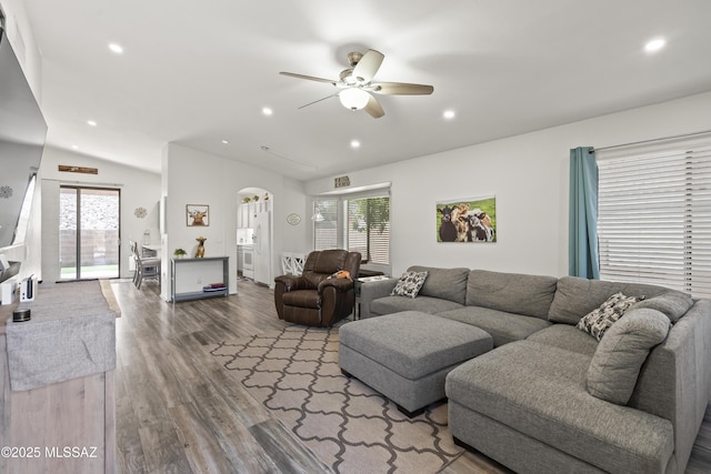 519 W Silvertip Rd, Tucson, AZ 85737 - living room featuring arched walkways, lofted ceiling, ceiling fan, healthy amount of natural light, and wood finished floors