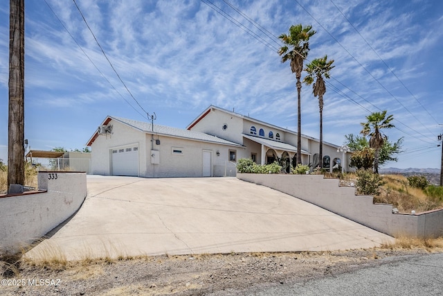333 Valley View Dr, Rio Rico, AZ 85648 - view of front facade featuring driveway, a garage, fence, and stucco siding