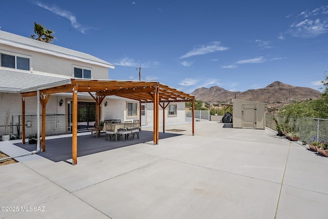 333 Valley View Dr, Rio Rico, AZ 85648 - view of patio with a pergola, a mountain view, a shed, fence, and an outbuilding