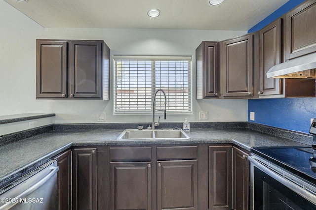 kitchen with appliances with stainless steel finishes, a sink, dark countertops, dark brown cabinets, and recessed lighting