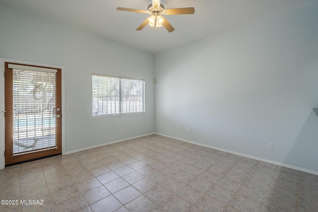 spare room featuring ceiling fan, baseboards, and light tile patterned floors
