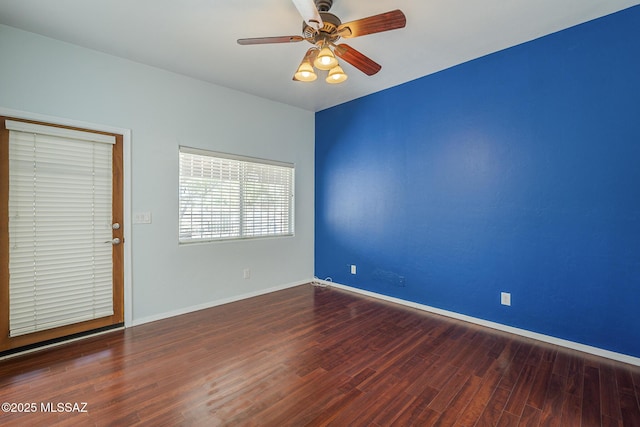 spare room featuring ceiling fan, wood finished floors, and baseboards