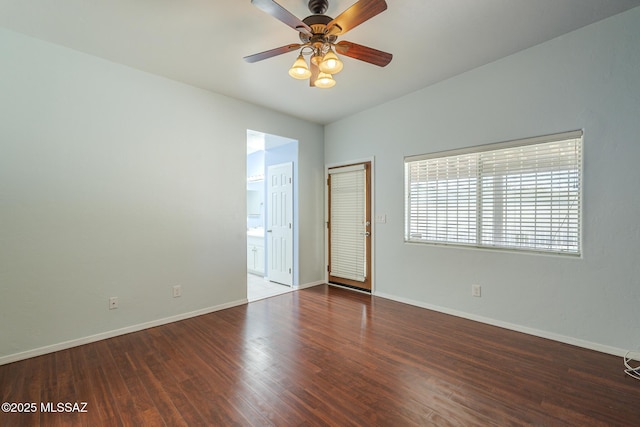spare room featuring ceiling fan, baseboards, and wood finished floors