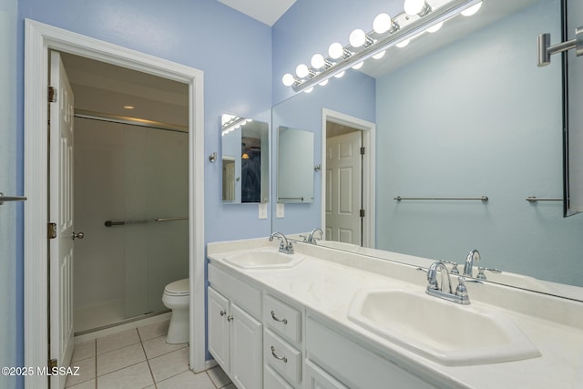bathroom with tile patterned flooring, toilet, a shower with door, and double vanity
